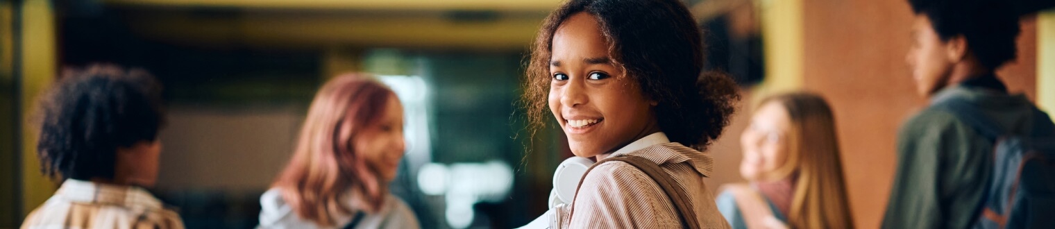 Young girl smiling in school hallway