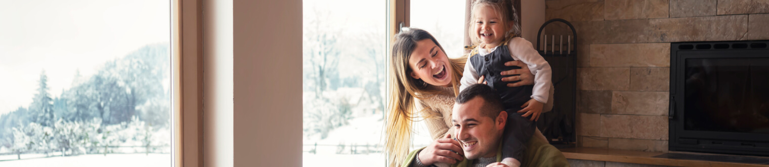 Family laughing together in living room.