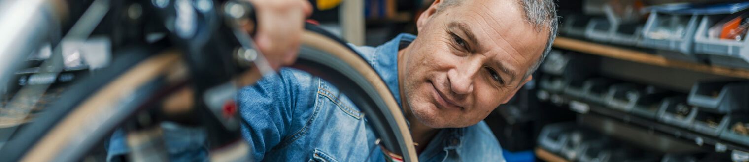 Business owner working on repairing bicycle tire.